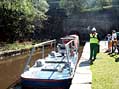 The electric tug boat is linked to a traditional passenger carrying steel narrow boat.